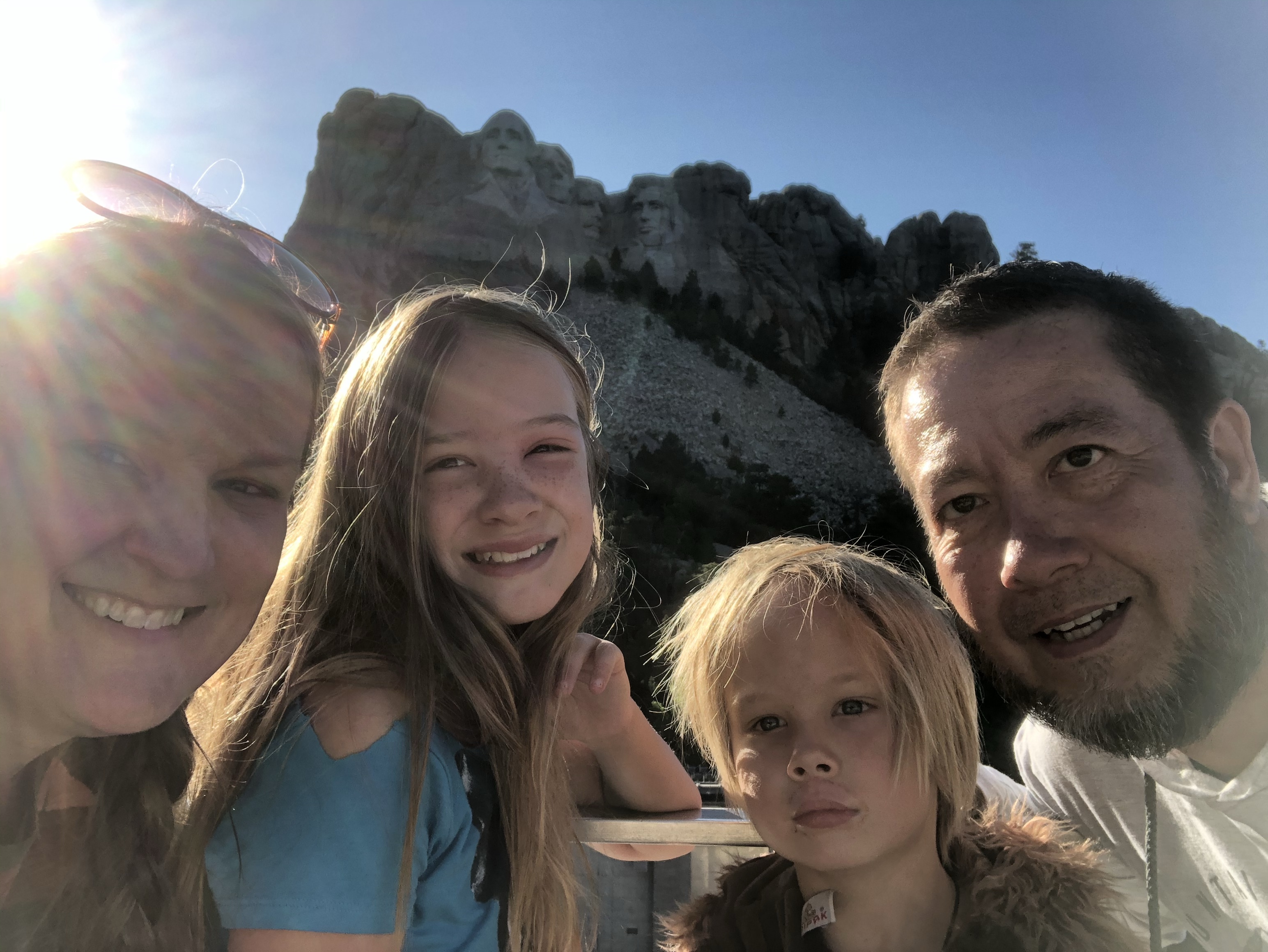 Our family standing in front of the faces of Mount Rushmore
