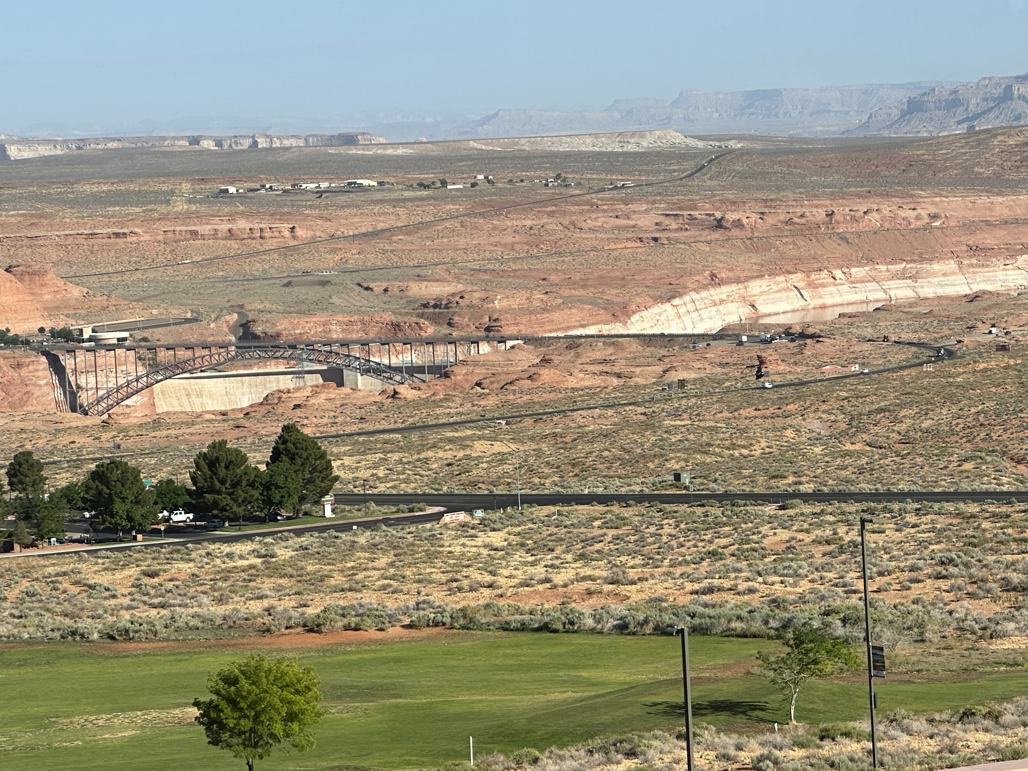 View of a dam from a distance at the beginning of a reservoir in sandstone cliffs